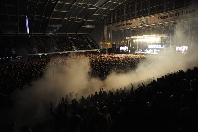 Night crowd view with lighting and smoke during Elton John’s concert at Forsyth Barr Stadium in Dunedin.